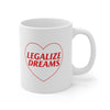 White ceramic coffee mug that has a red heart with Legalize Dreams written on it.