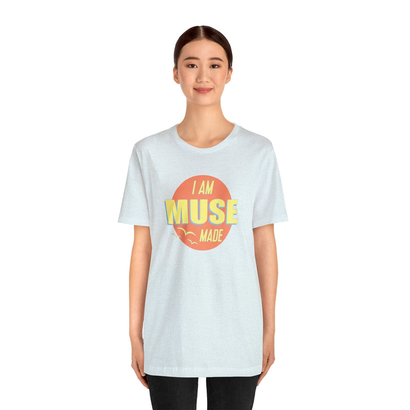 Female model wearing light blue T-shirt that says I am Muse Made.