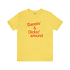 Top Knot Goods yellow cotton t-shirt that says Dancin and Dickin Around.