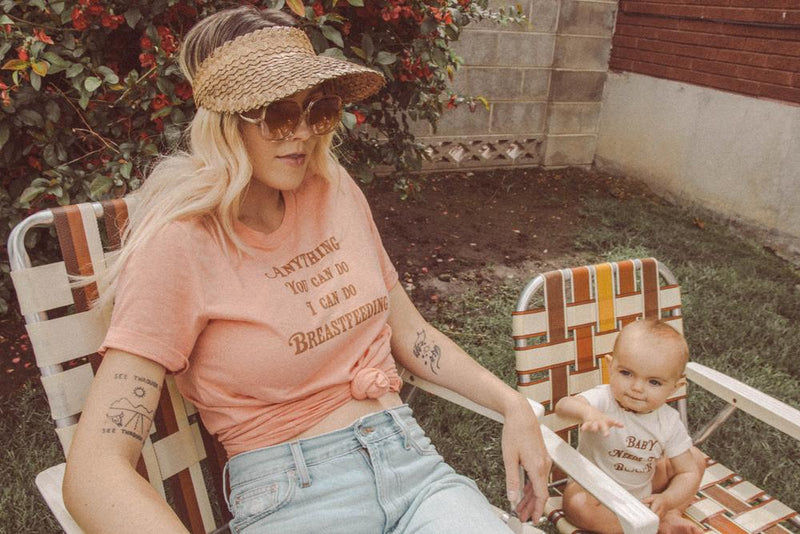 Mother and baby both sitting in lawn chairs wearing Top Knot Goods t-shirts