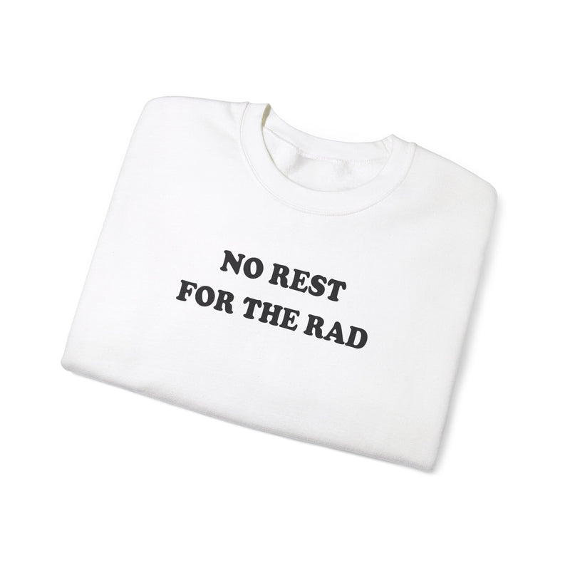 Folded white cotton crewneck sweatshirt with black writing that says No Rest for the Rad.