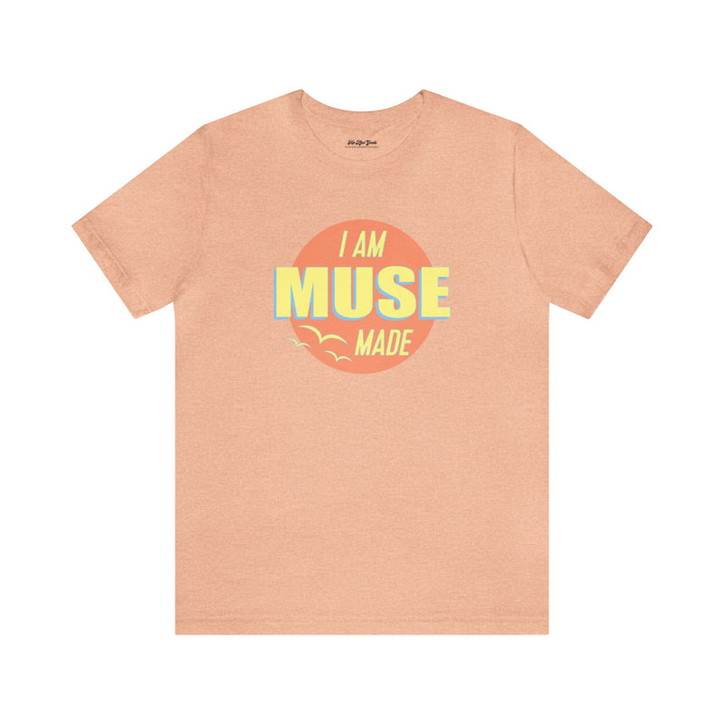 Peach colored T-shirt that says I am Muse Made.