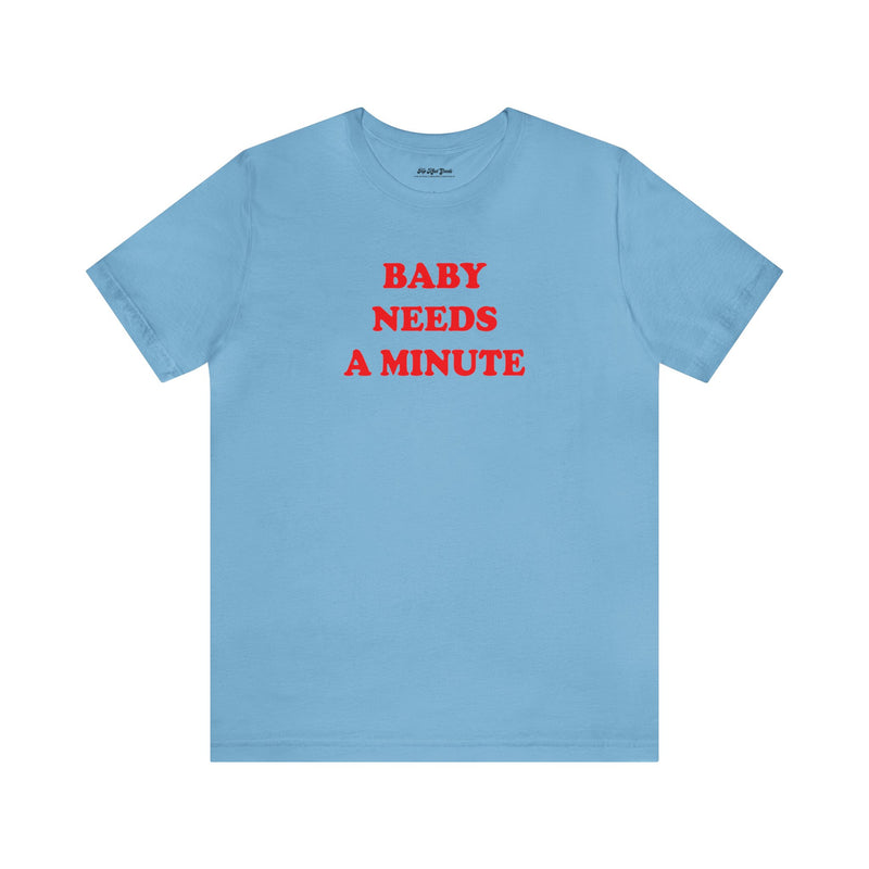 Top Knot Goods baby blue shir that says "Baby Needs a Minute."."