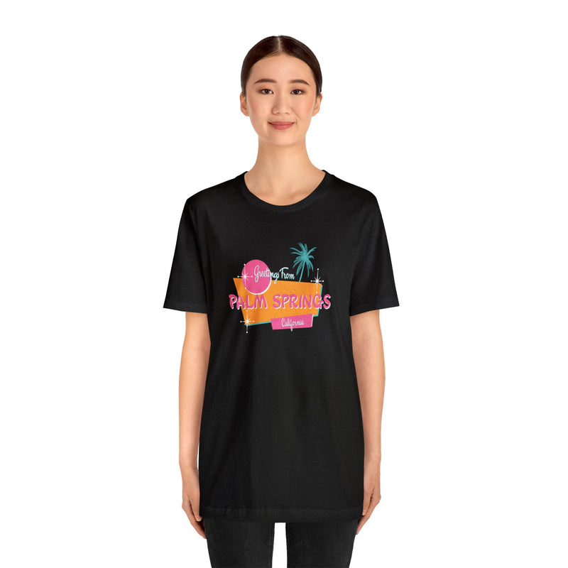 Female Model wearing black Greetings from Palm Spings California T-Shirt.