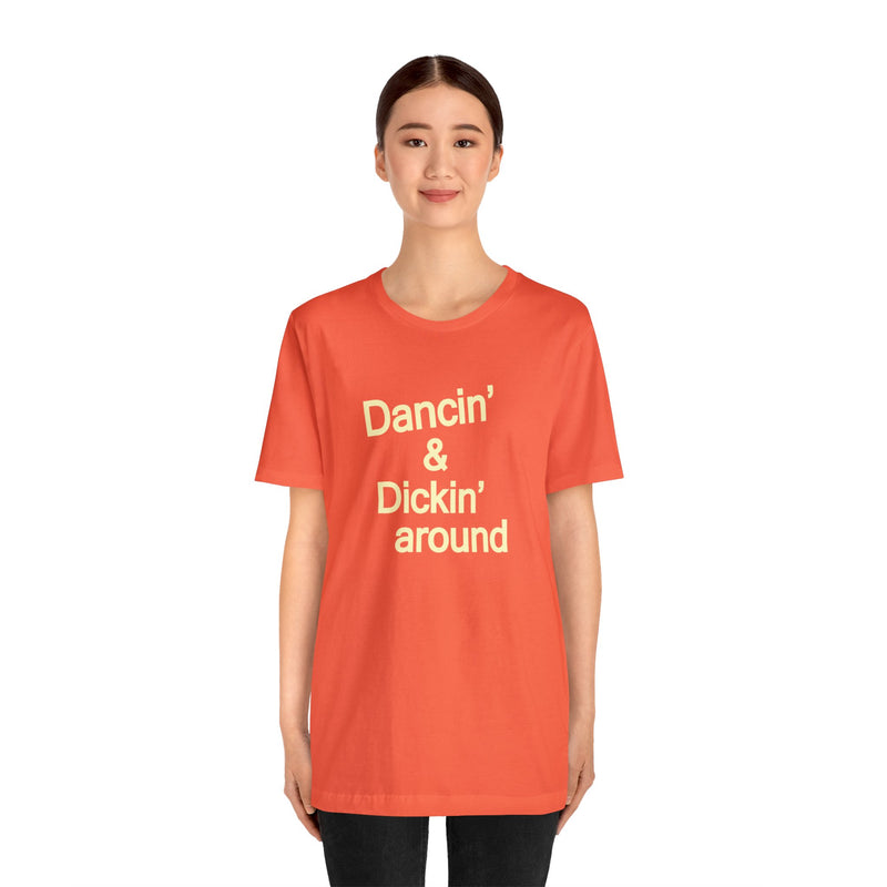 Female model wearing Top Knot Goods orange cotton t-shirt that says Dancin and Dickin Around.