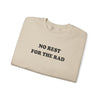 Folded sand colored cotton crewneck sweatshirt with black writing that says No Rest for the Rad.