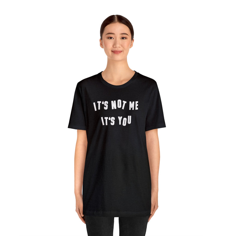 Female model wearing Top Knot Goods Black cotton T-Shirt that says Its Not Me Its You. 