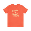 Top Knot Goods orange cotton t-shirt that says Dancin and Dickin Around.