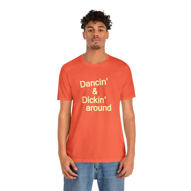 Male model wearing Top Knot Goods orange cotton t-shirt that says Dancin and Dickin Around.