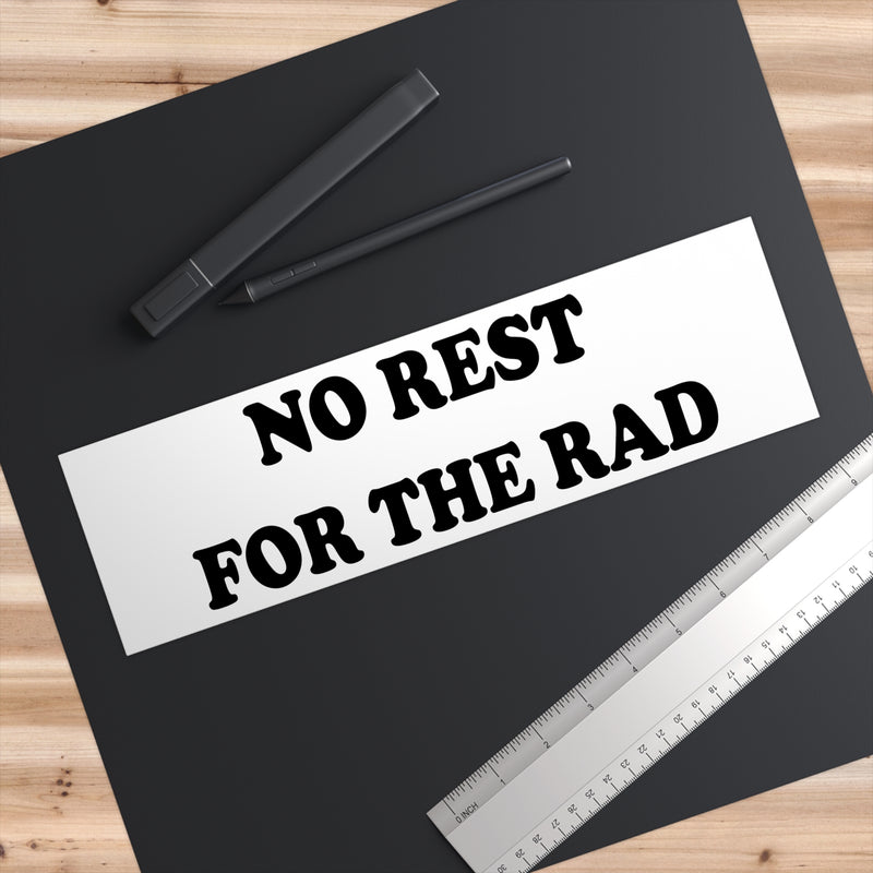 11x3 inch No Rest for the Rad Bumper Sticker on a notebook.