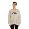 Model wearing sand colored crewneck sweatshirt that says No Rest for the Rad in black writing. 