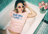 Girl laying in bathtub with Play Nice Girls cotton T-Shirt.