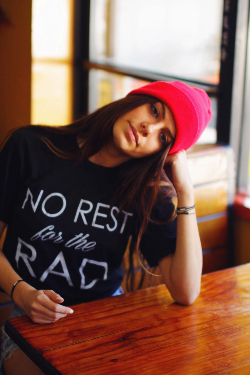 Soft black cotton T-Shirt that says No Rest for the Rad. 