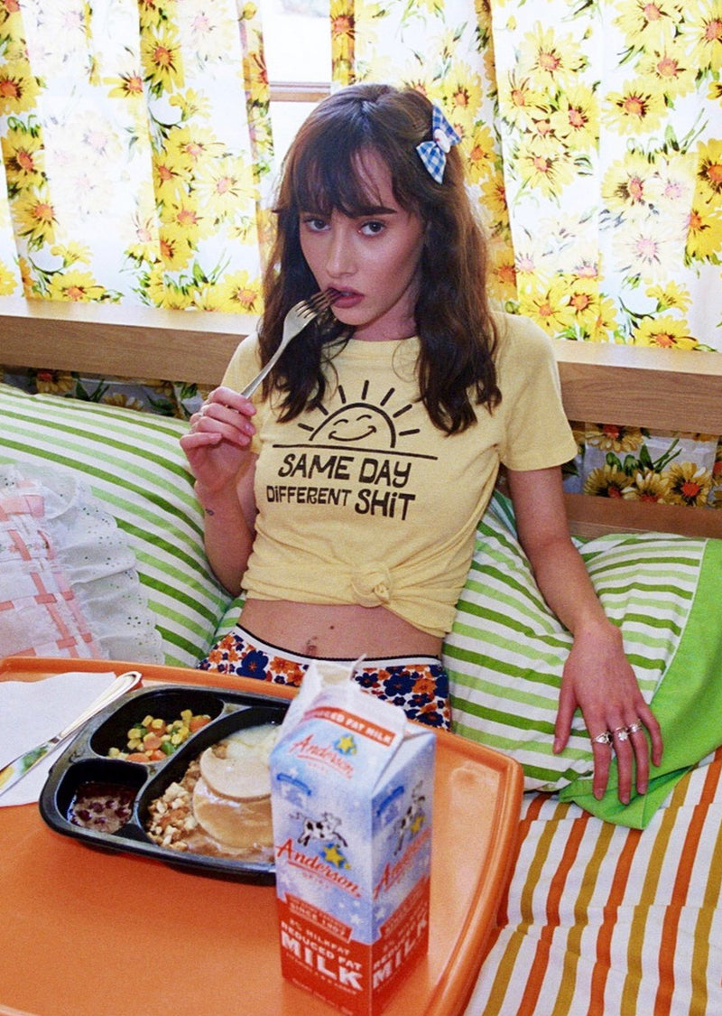 Model wearing Top Knot Goods yellow Same Day Different Shit cotton T-Shirt.