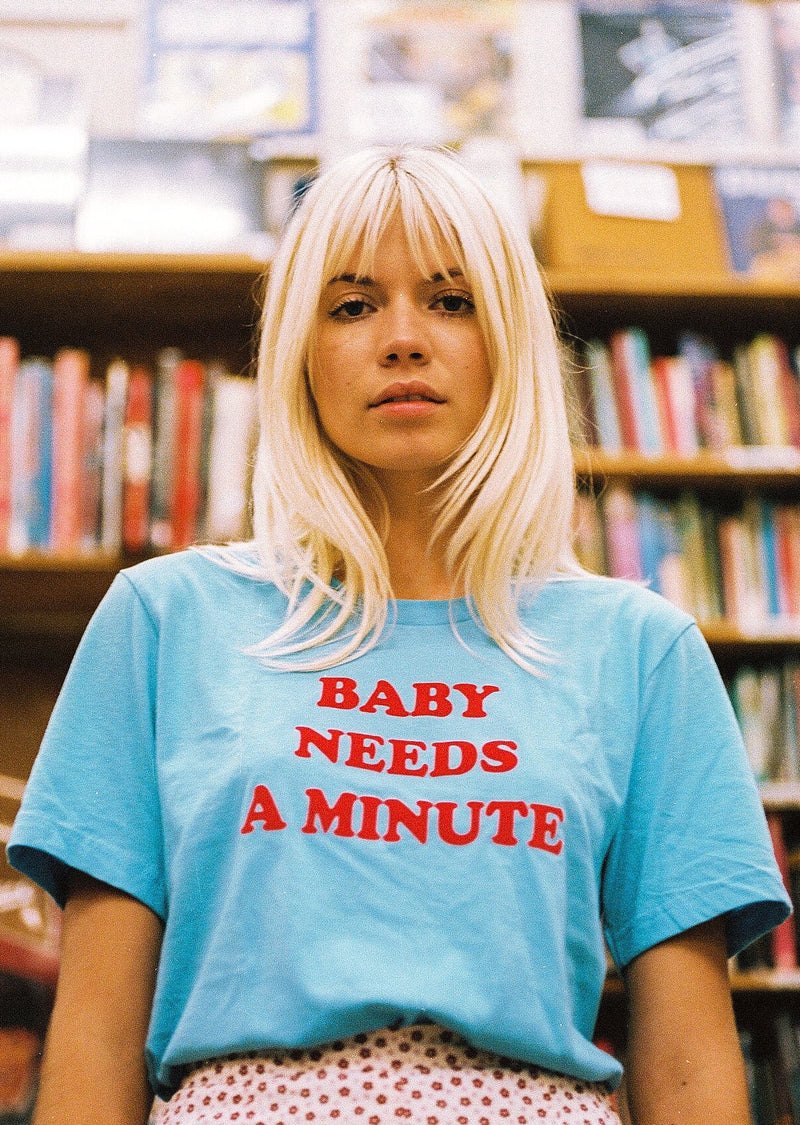 Top Knot Goods T-Shirt that says "Baby Needs a Minute."