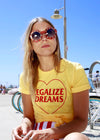 Girl wearing yellow shirt with red writing that reads Legalize Dreams with a red heart outline