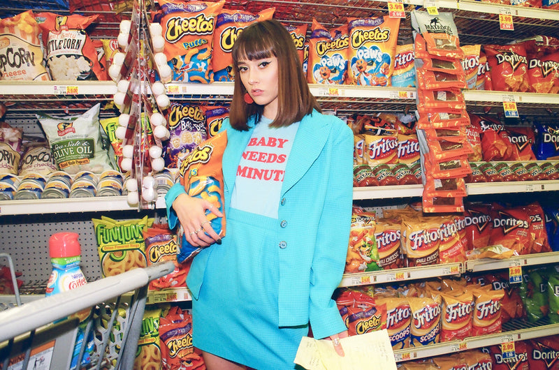 Girl in supermarket wearing blue vintage 70s t-shirt